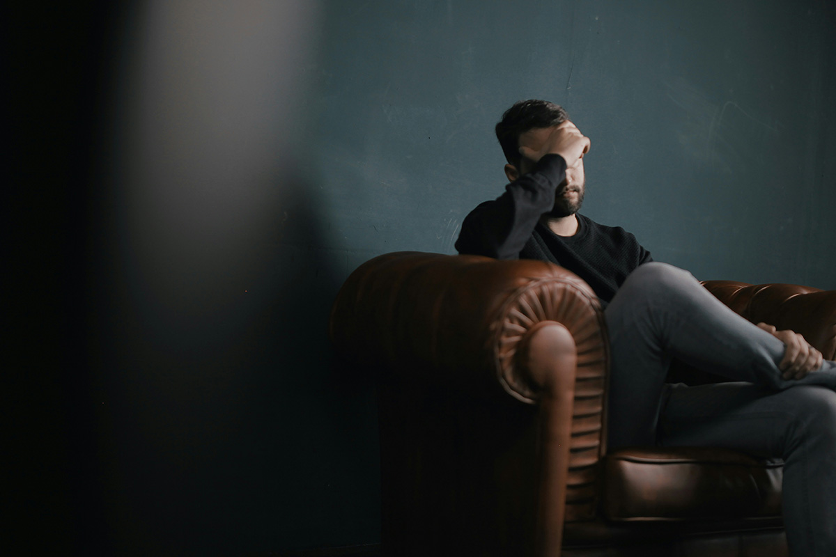 head to heart restoration ministry article image showing man sitting on sofa in deep thought