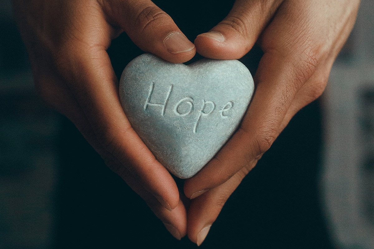 head to heart restoration ministry creating new beginnings with Christian therapy article image of a man holding heart shaped stone engraved with the word hope